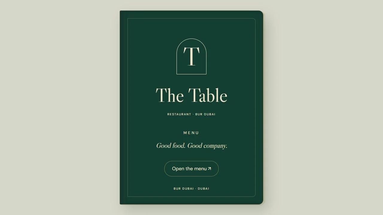 The Table: Menu book cover on a laptop