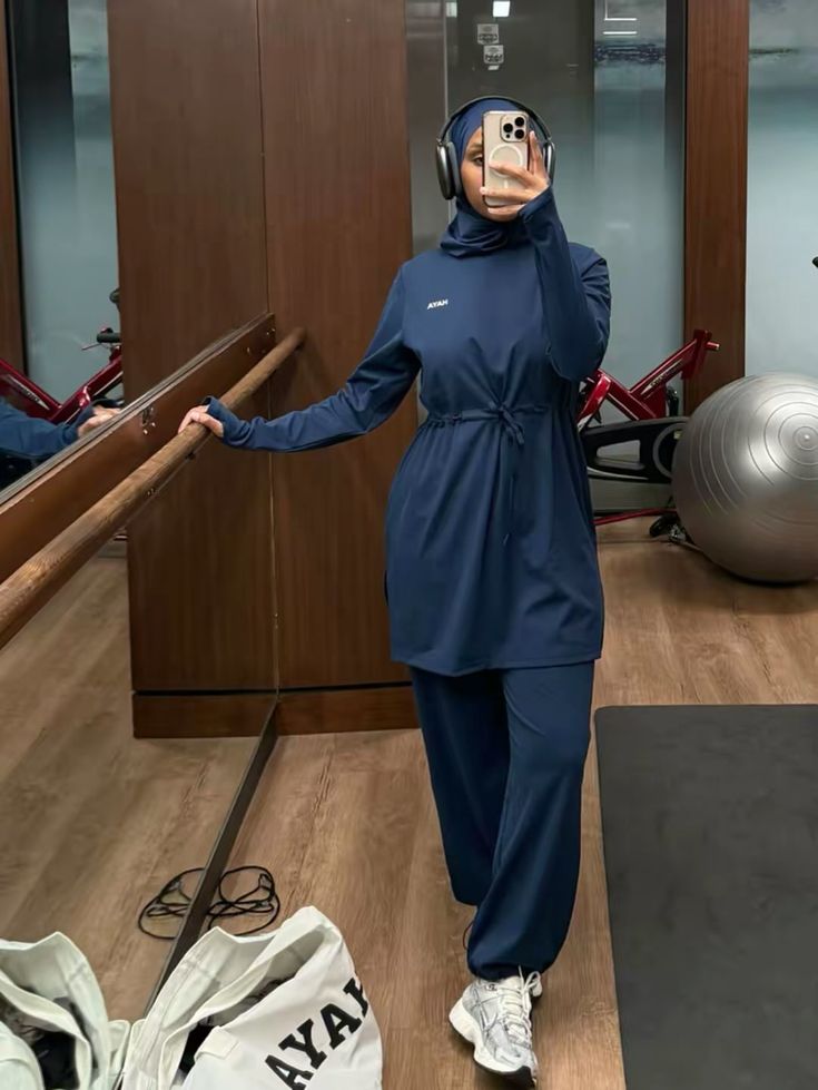 Woman in modest activewear at a gym