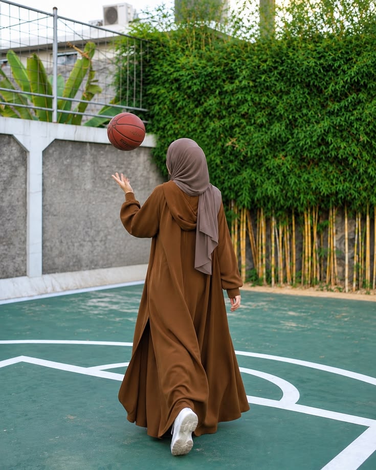 Woman enjoying movement on an outdoor basketball court